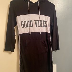 Dress It’s Black it says good vibes it has a little hood in the back